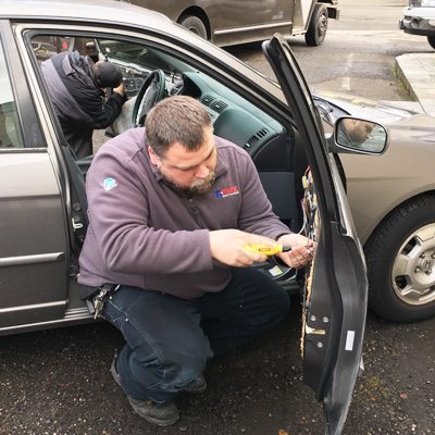 Bill Blanchard making a lock repair on a Honda