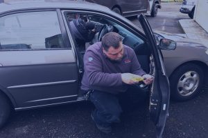 Job site photo of Bill Blanchard fixing a Honda lock issue